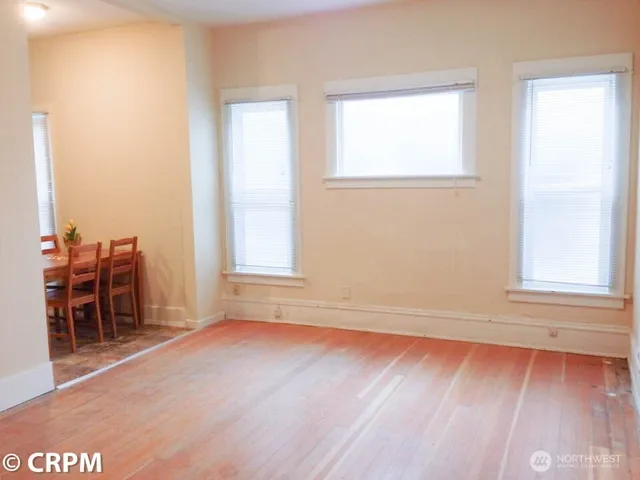 an empty room with windows and closet