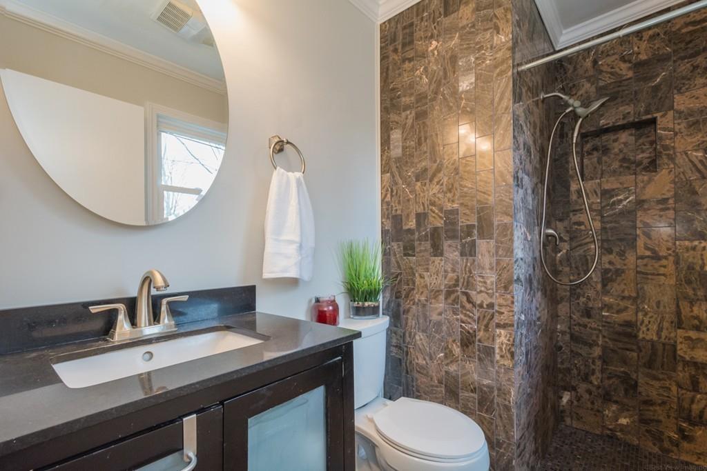 35 Barton Road Stow, MA 01775 - Photo 13 of 28 a bathroom with a granite countertop sink toilet a mirror and shower curtain