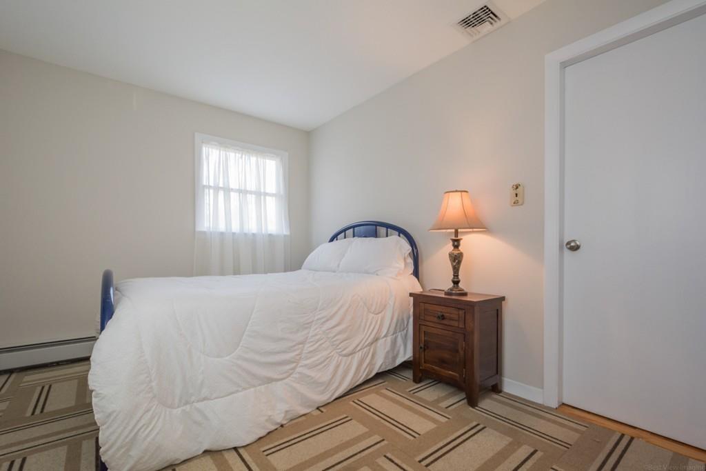 35 Barton Road Stow, MA 01775 - Photo 16 of 28 a bedroom with a bed and a window