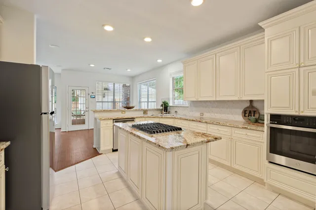 a kitchen with a stove a sink and a refrigerator
