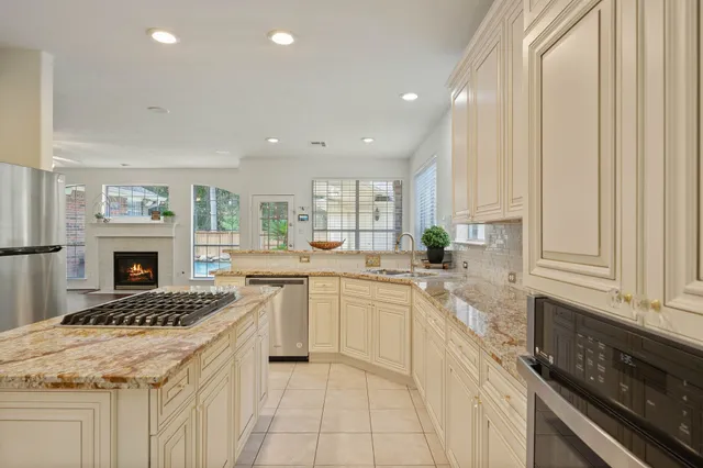a kitchen with a stove sink and cabinets