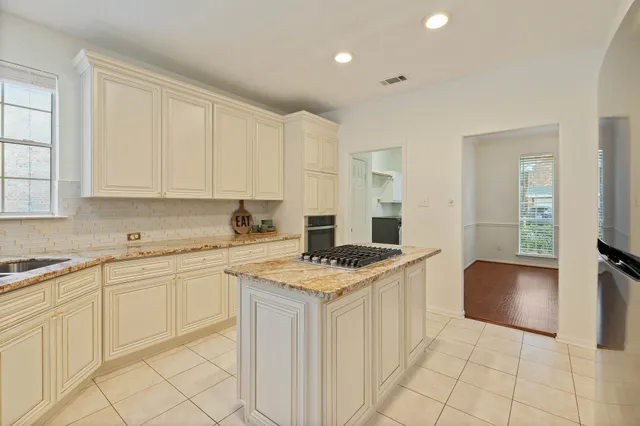 a kitchen with a stove sink and cabinets