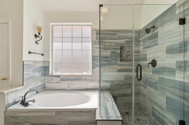 a bathroom with a bathtub and shower