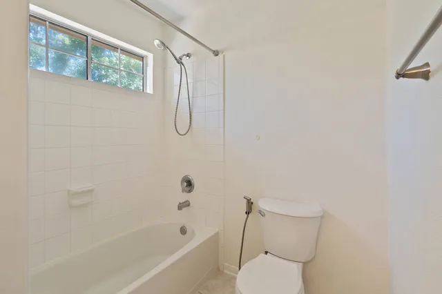 a bathroom with a toilet and a shower
