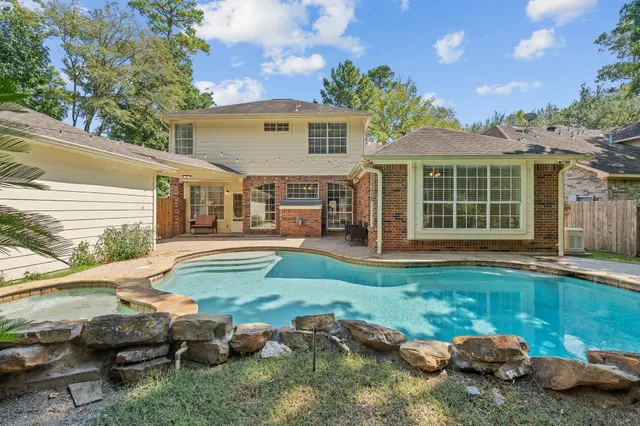 a view of a house with backyard and sitting area