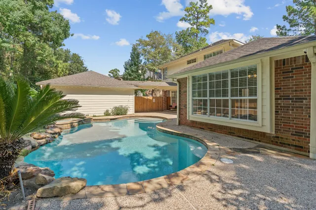 a view of a house with backyard and sitting area