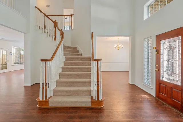 a view of entryway and hall with wooden floor