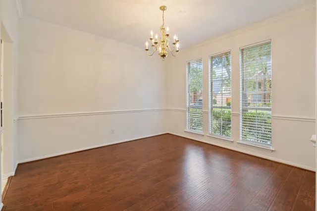 a view of a room with wooden floor and large window