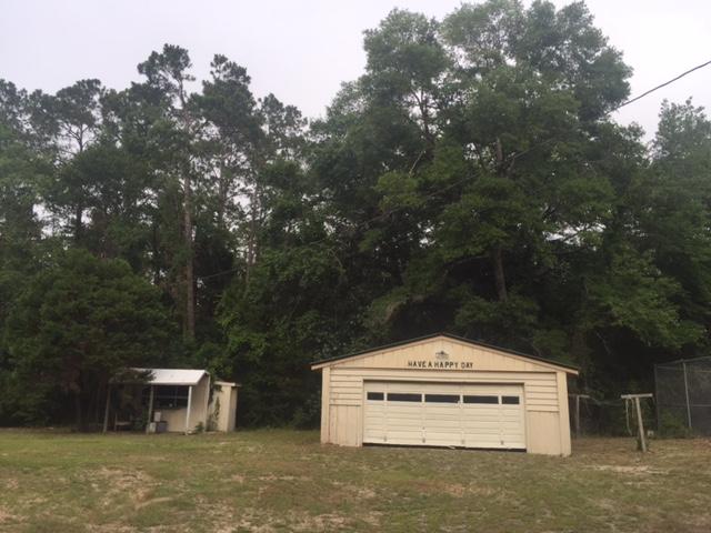 692 Piney Point Road Freeport, FL 32439 - Photo 15 of 17 a front view of a house with a yard