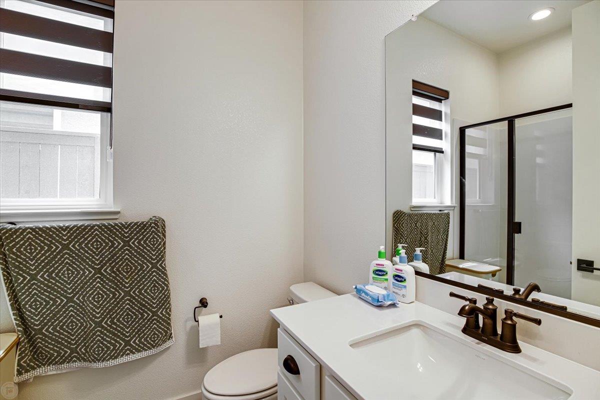 4205 Maddy Avenue Tracy, CA 95377 - Photo 19 of 45 a bathroom with a sink toilet and mirror