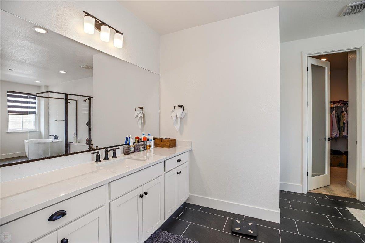 4205 Maddy Avenue Tracy, CA 95377 - Photo 26 of 45 a bathroom with a double vanity sink and a mirror