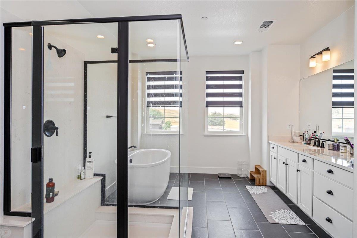 4205 Maddy Avenue Tracy, CA 95377 - Photo 27 of 45 a bathroom with a granite countertop sink a toilet and shower