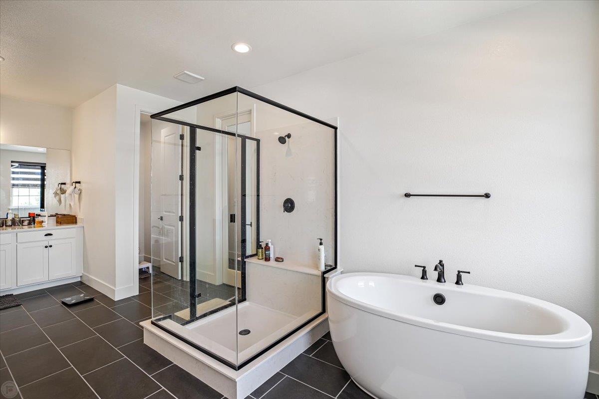 4205 Maddy Avenue Tracy, CA 95377 - Photo 28 of 45 a bathroom with a sink a mirror and a shower