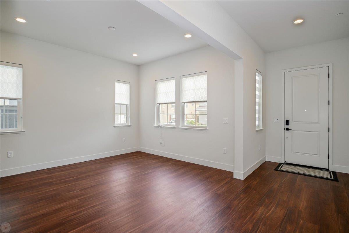 4205 Maddy Avenue Tracy, CA 95377 - Photo 3 of 45 an empty room with wooden floor and windows