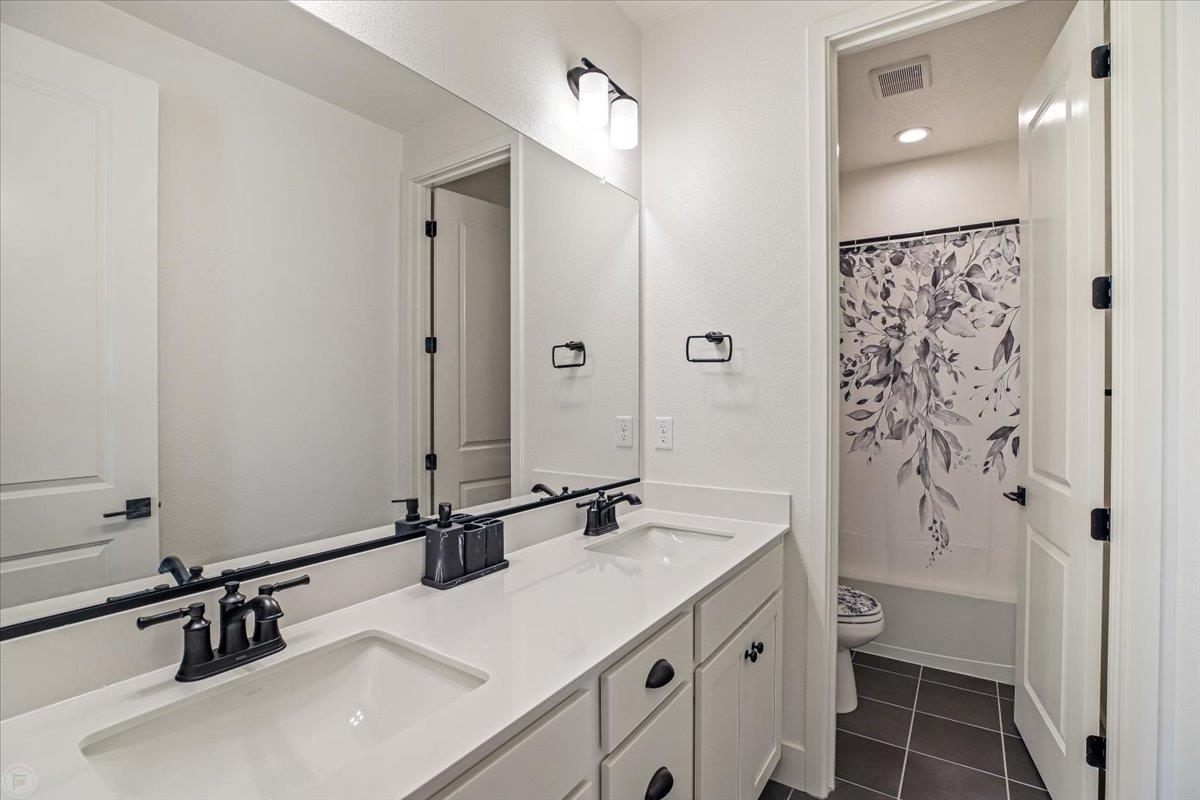 4205 Maddy Avenue Tracy, CA 95377 - Photo 33 of 45 a bathroom with a sink and a mirror