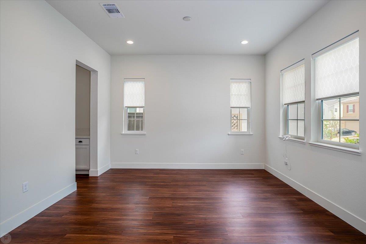 4205 Maddy Avenue Tracy, CA 95377 - Photo 4 of 45 an empty room with wooden floor and windows