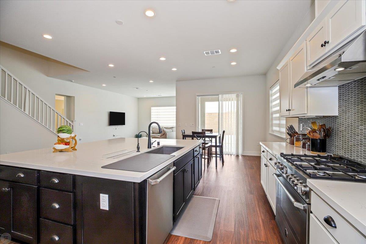 4205 Maddy Avenue Tracy, CA 95377 - Photo 8 of 45 a kitchen with counter top space a sink stainless steel appliances and cabinets