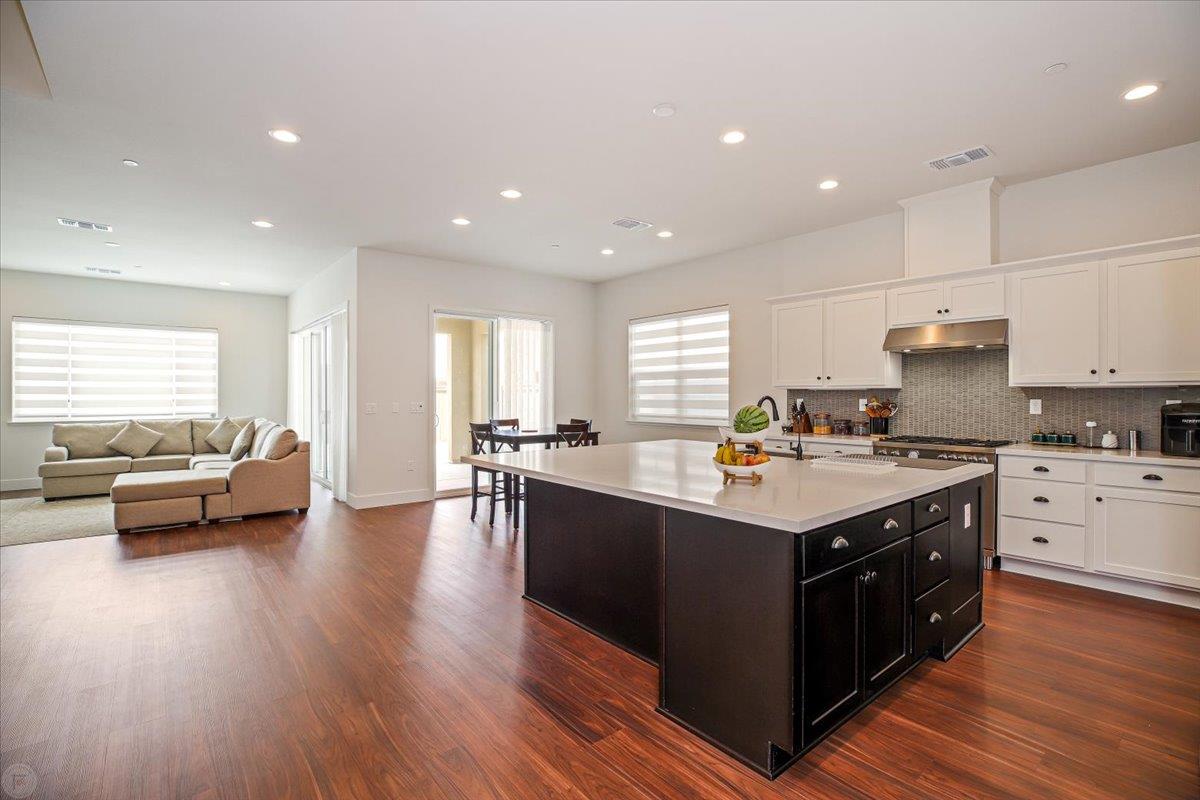 4205 Maddy Avenue Tracy, CA 95377 - Photo 10 of 45 a kitchen with kitchen island granite countertop a sink a stove and cabinets