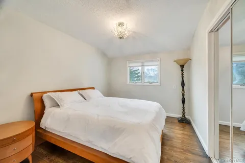 a bathroom with a granite countertop sink mirror vanity and a toilet