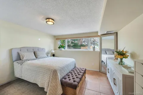 a bathroom with a tub sink and mirror