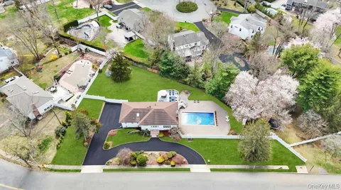 an aerial view of a house with garden space and street view