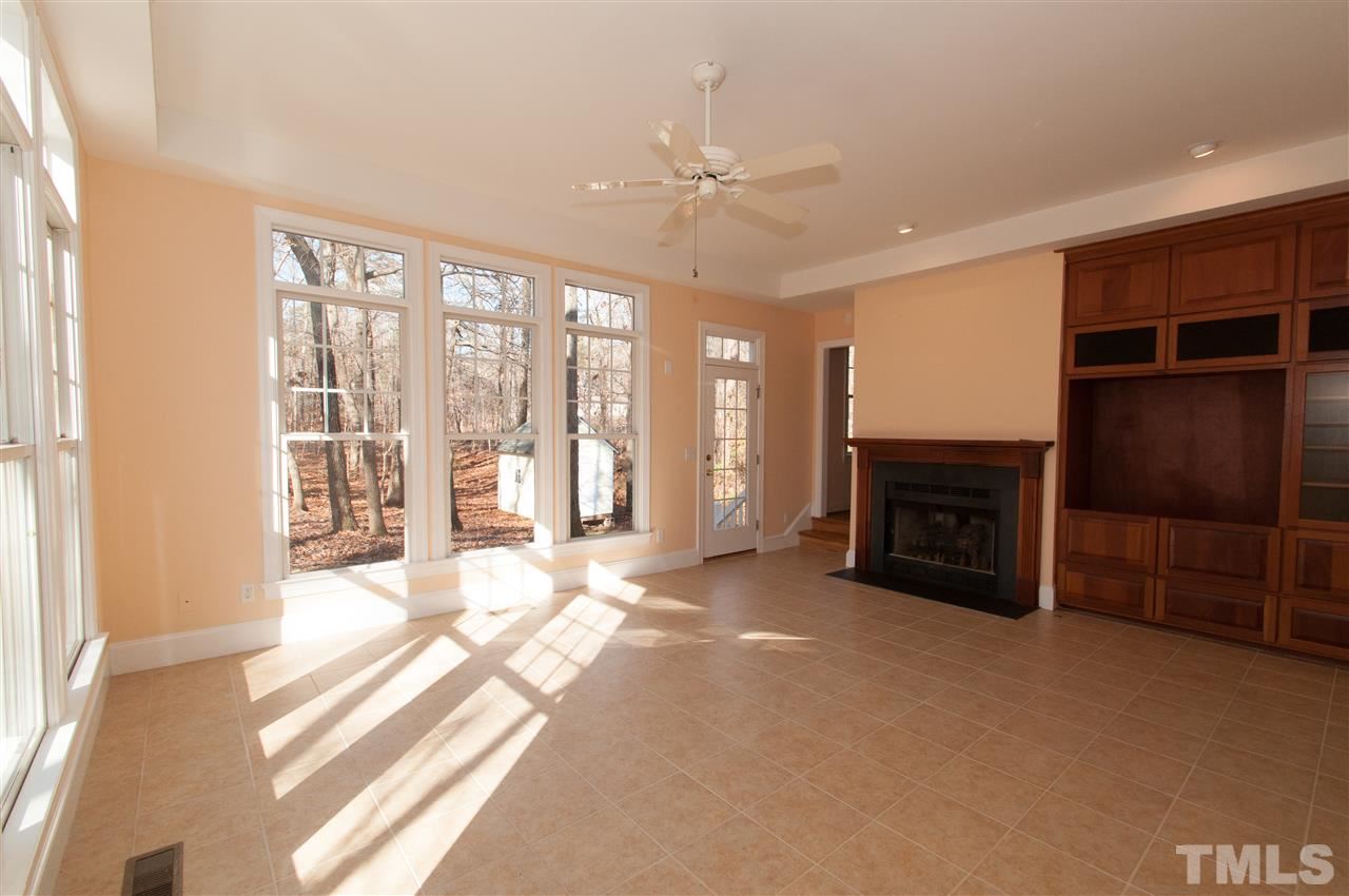 13423 Melvin Arnold Road Raleigh, NC 27613 - Photo 12 of 25 Sun-filled family room or rec room with gas log fireplace, built in entertainment center and access to computer/office area and backyard