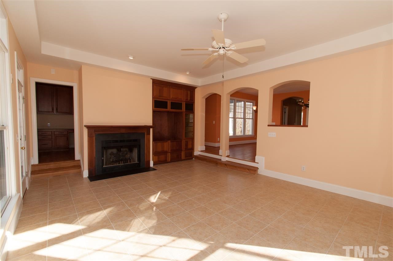 13423 Melvin Arnold Road Raleigh, NC 27613 - Photo 13 of 25 Sun-filled family room or rec room with gas log fireplace, built in entertainment center and access to computer/office area and backyard