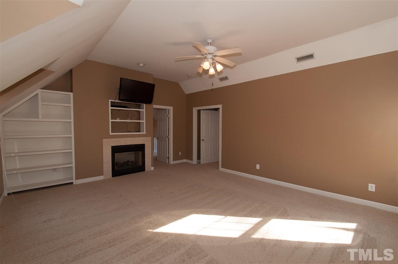 13423 Melvin Arnold Road Raleigh, NC 27613 - Photo 16 of 25 Spacious master suite with see thru gas log fireplace, sitting room, whirlpool bath and walk-in closet