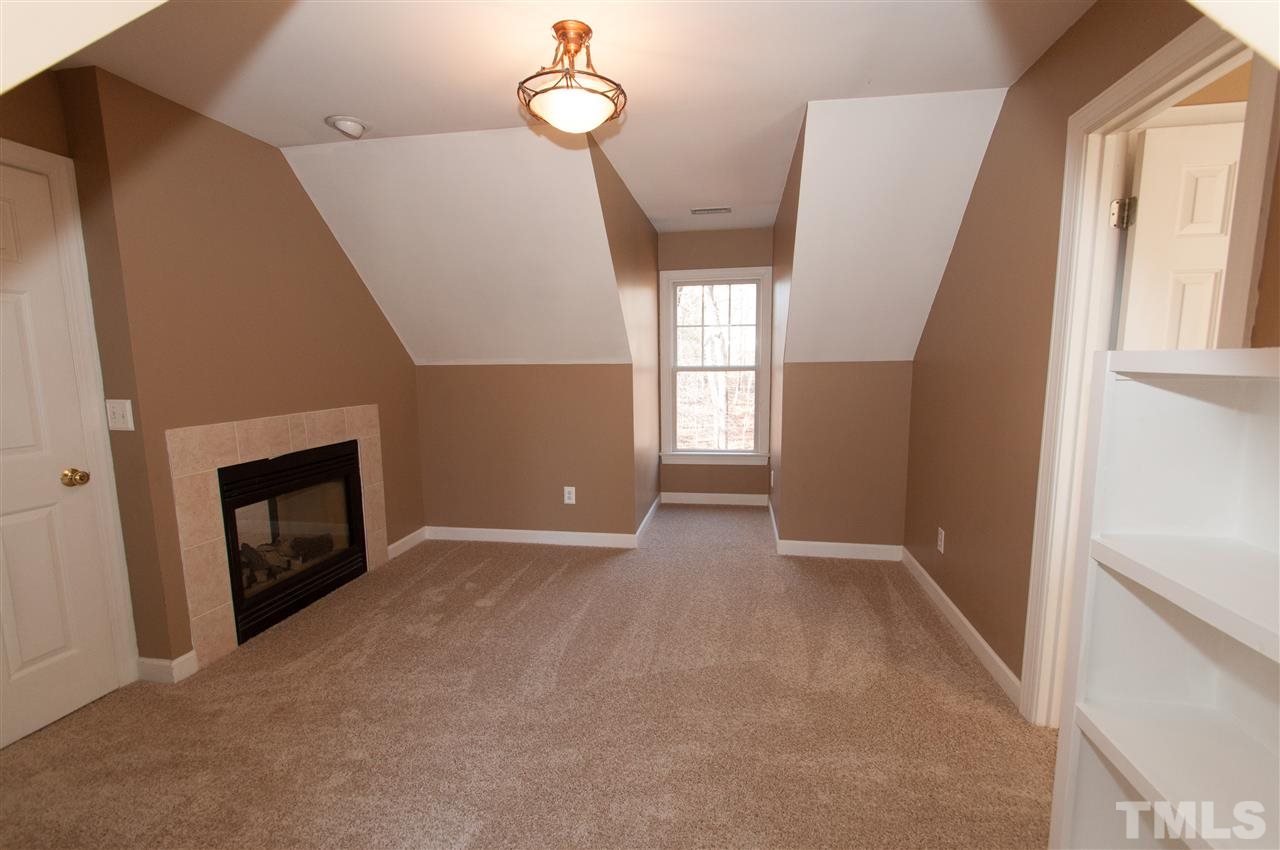 13423 Melvin Arnold Road Raleigh, NC 27613 - Photo 17 of 25 Spacious master suite with see thru gas log fireplace, sitting room, whirlpool bath and walk-in closet