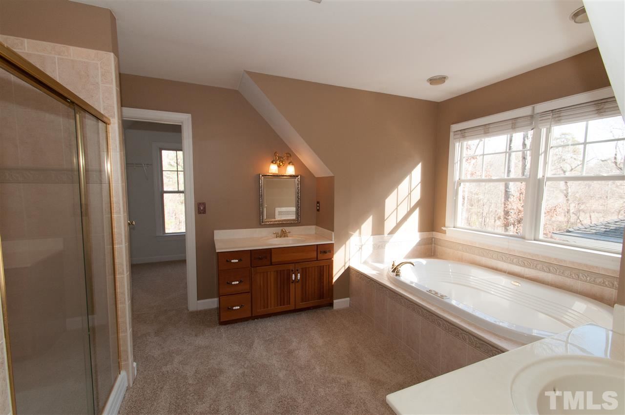 13423 Melvin Arnold Road Raleigh, NC 27613 - Photo 18 of 25 Spacious master suite with see thru gas log fireplace, sitting room, whirlpool bath and walk-in closet