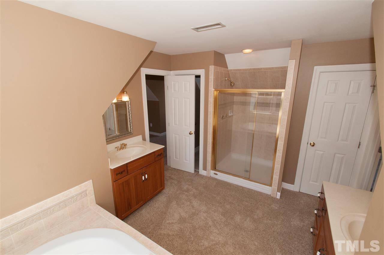 13423 Melvin Arnold Road Raleigh, NC 27613 - Photo 19 of 25 Spacious master suite with see thru gas log fireplace, sitting room, whirlpool bath and walk-in closet
