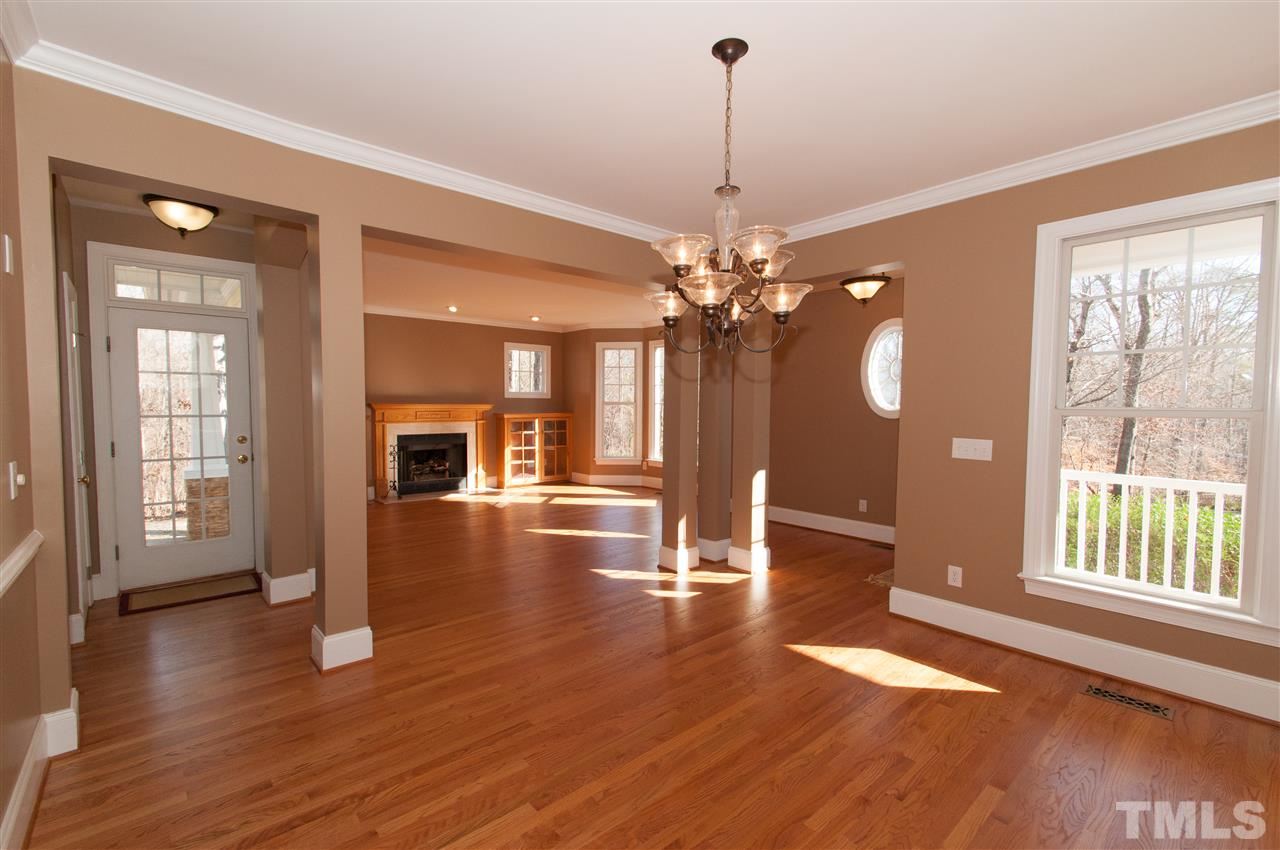 13423 Melvin Arnold Road Raleigh, NC 27613 - Photo 6 of 25 Spacious formal room with lovely chandelier and hardwood floors