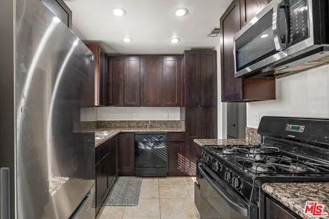 a kitchen with a sink stove and cabinets
