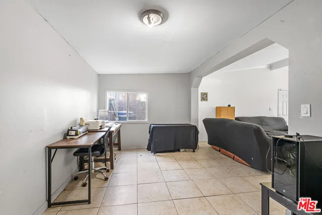 a bathroom with a granite countertop sink and a toilet