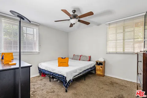 a bedroom with a bed and a cabinet