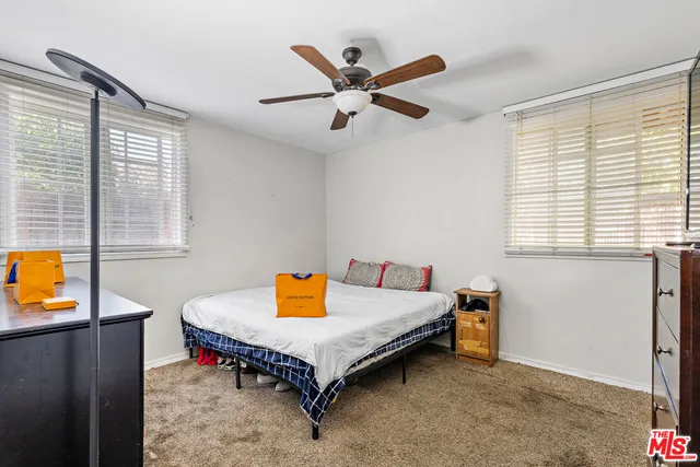 a bedroom with a bed and a cabinet