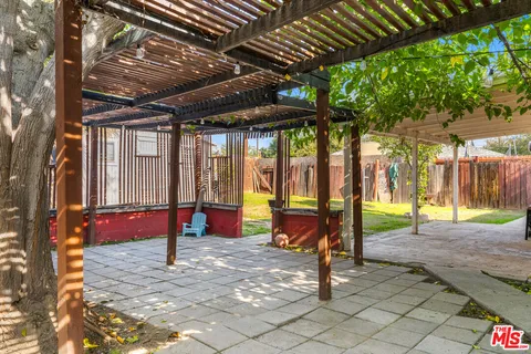 a view of a backyard with a tv and outdoor seating