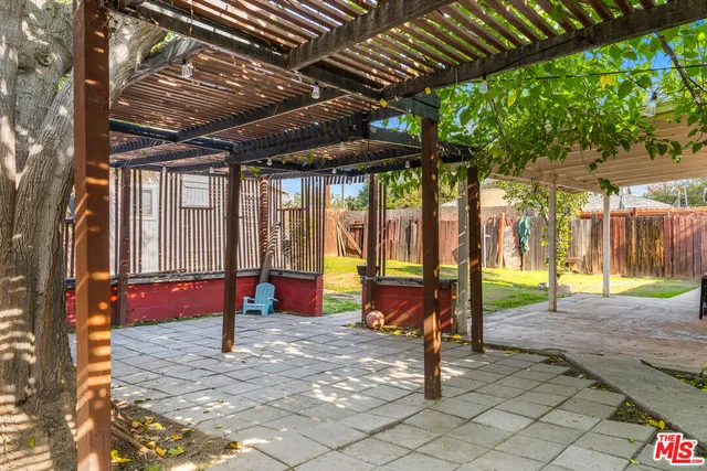 a view of a backyard with a tv and outdoor seating