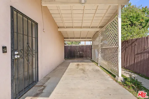 a living room with furniture a window and a flat screen tv