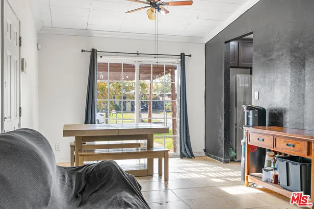 a living room with a couch and a floor to ceiling window
