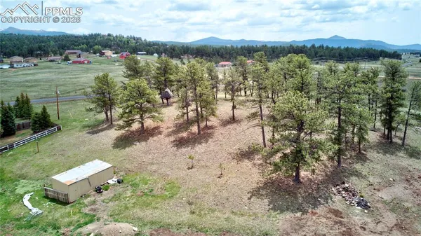 a view of a lake with a yard and a fountain