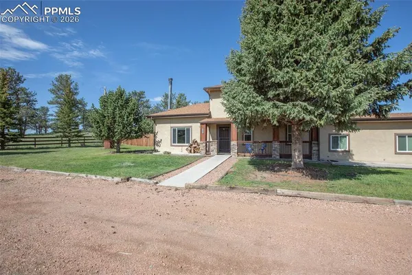 a view of house with outdoor space and trees