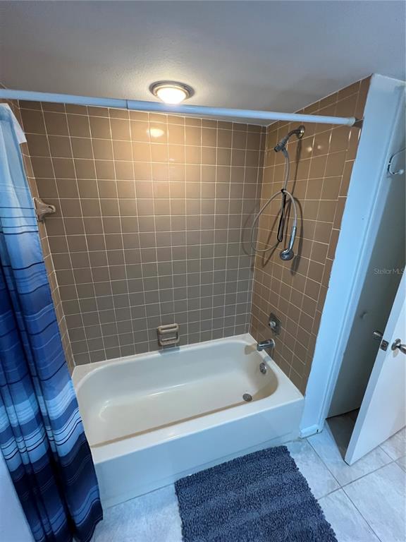 7110 Cognac Drive, Unit 2 New Port Richey, FL 34653 - Photo 14 of 24 a bathroom with a bathtub and a shower