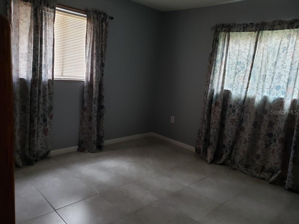 7110 Cognac Drive, Unit 2 New Port Richey, FL 34653 - Photo 22 of 24 an empty room with windows