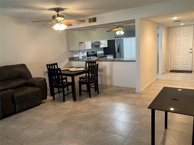 a view of a dining room with furniture and a chandelier