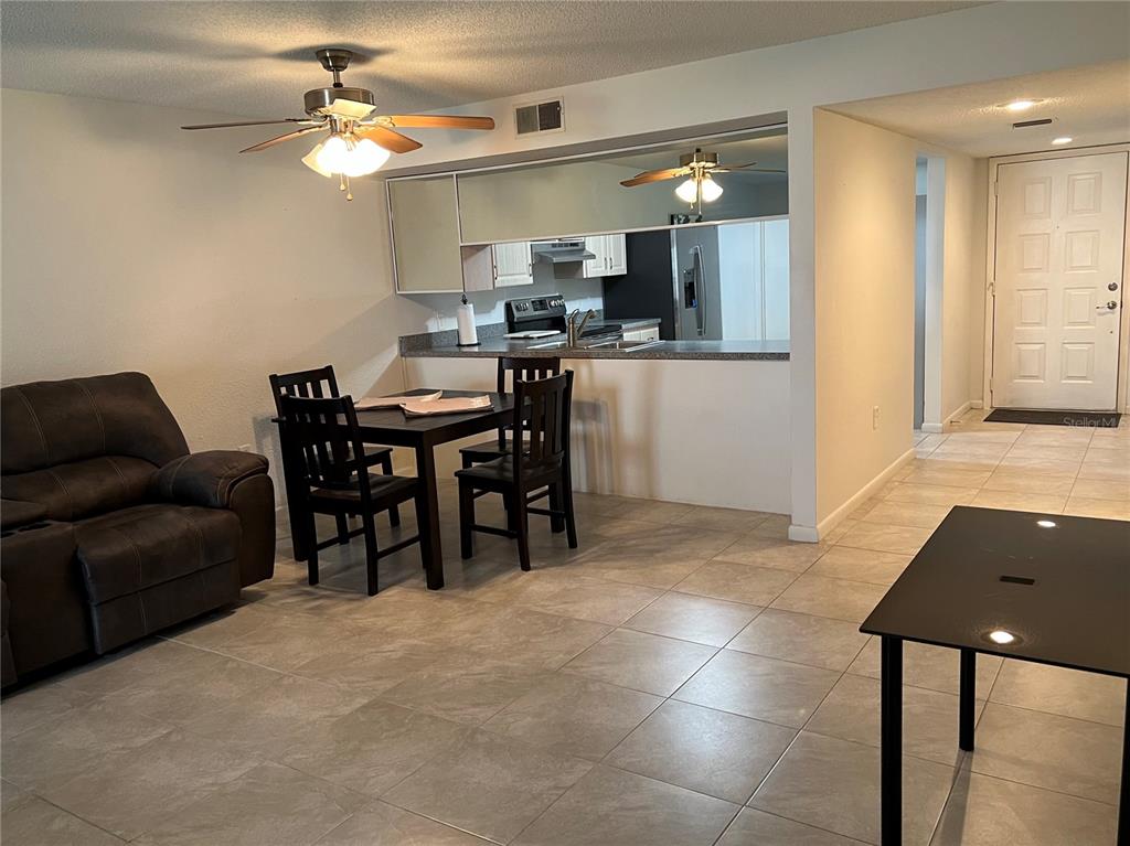 7110 Cognac Drive, Unit 2 New Port Richey, FL 34653 - Photo 5 of 24 a view of a dining room with furniture and a chandelier