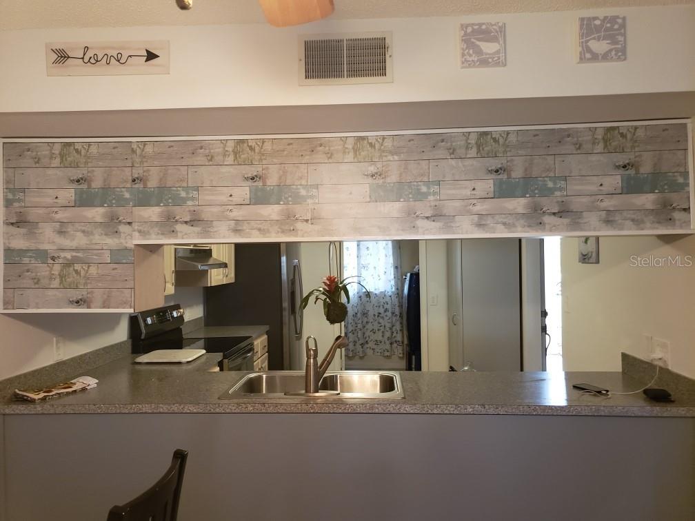 7110 Cognac Drive, Unit 2 New Port Richey, FL 34653 - Photo 6 of 24 a bathroom with a sink and a mirror