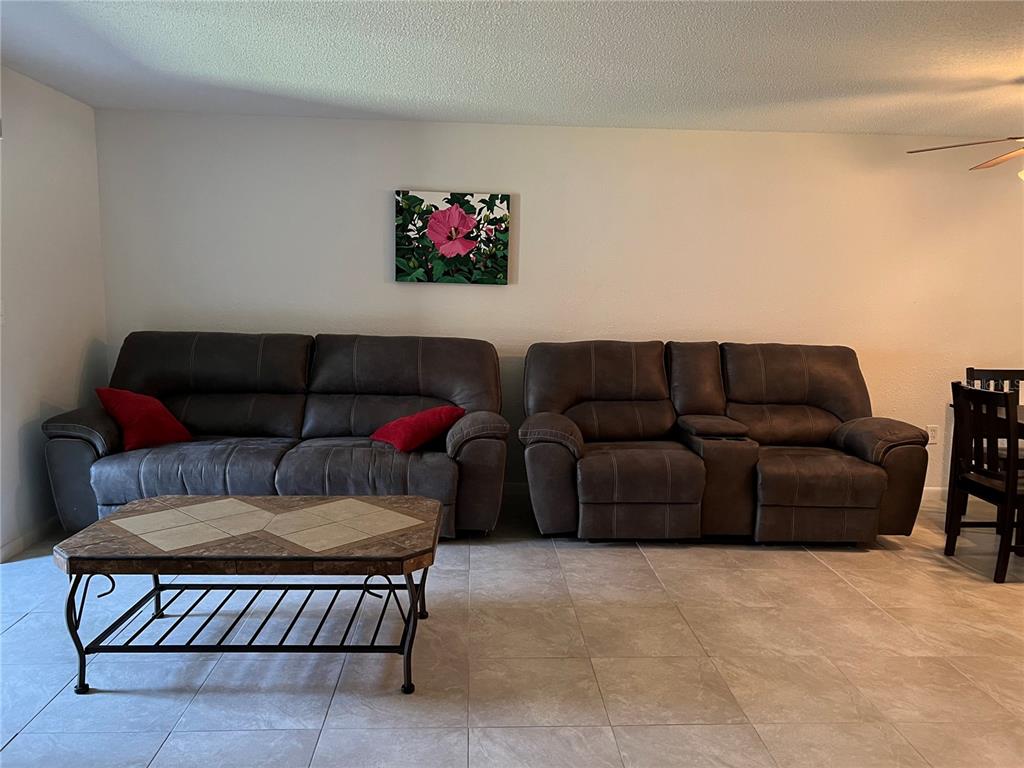 7110 Cognac Drive, Unit 2 New Port Richey, FL 34653 - Photo 8 of 24 a living room with furniture a couch and a potted plant