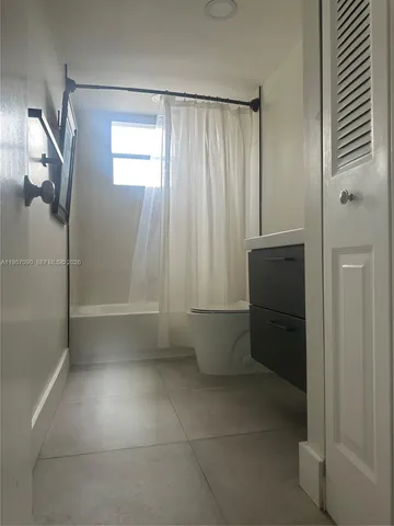 a bathroom with a shower and a sink