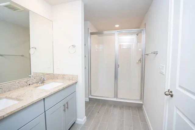 a bathroom with a granite countertop sink mirror and double